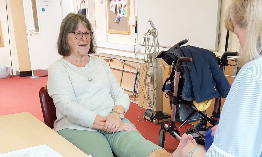 Footcare at our Hub Lady having a foot treatment by another lady at a community centre